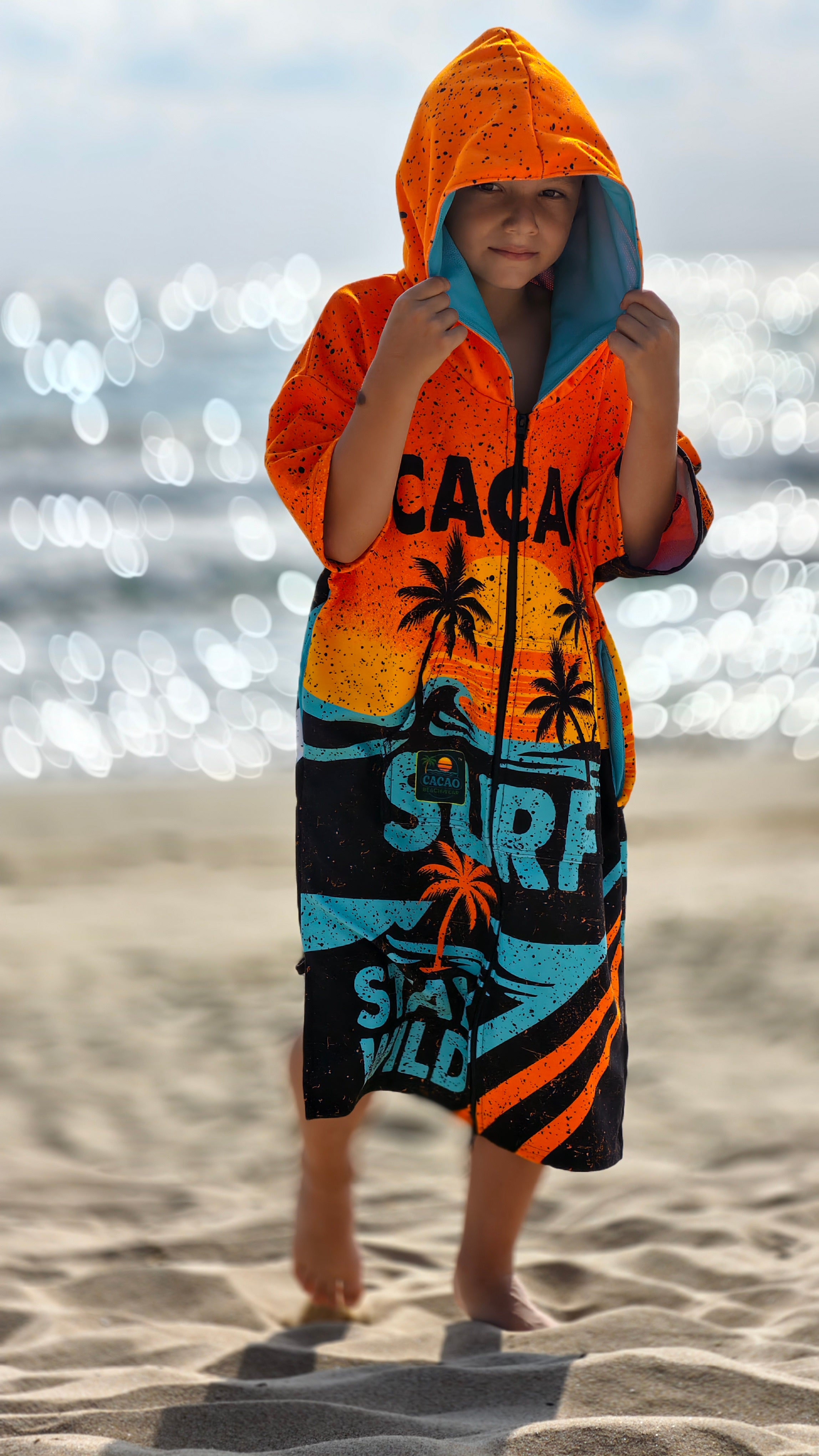 Orange children’s beach poncho towel for boys with hood, zipper and pockets – CACAO Beachwear™